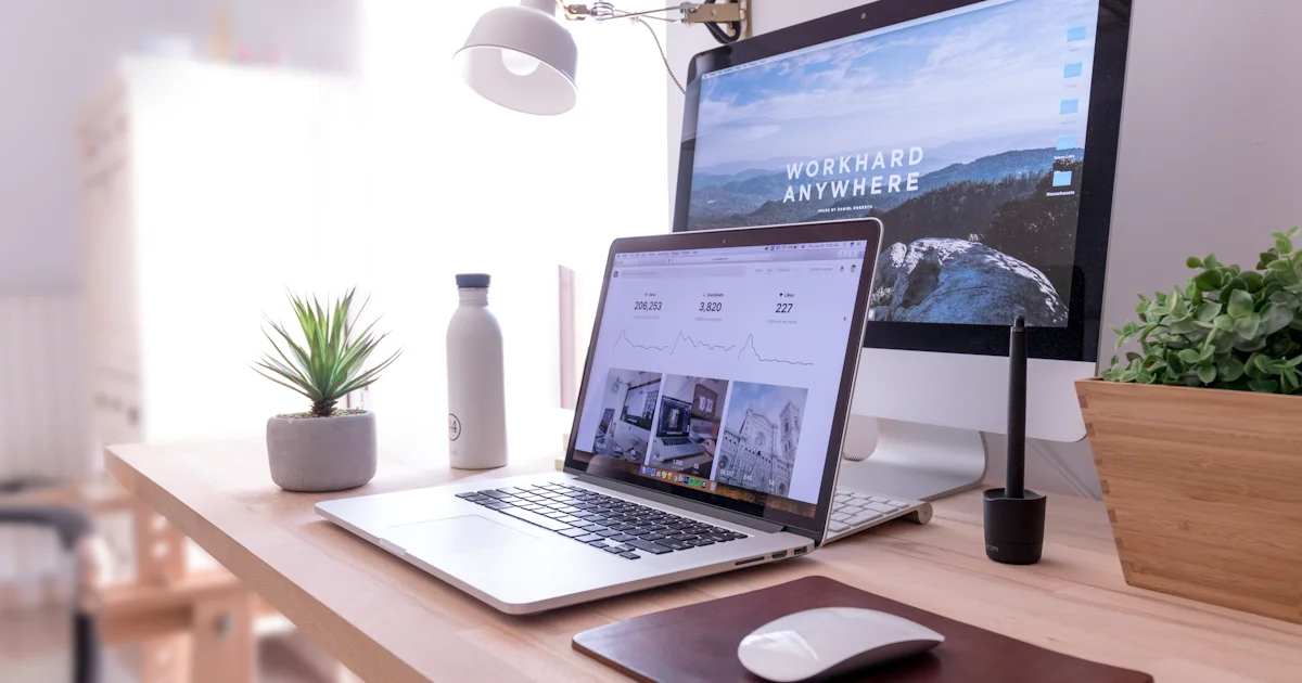 Laptop and monitor on a desk representing the Shopify vs Wix vs Webflow website builder comparison