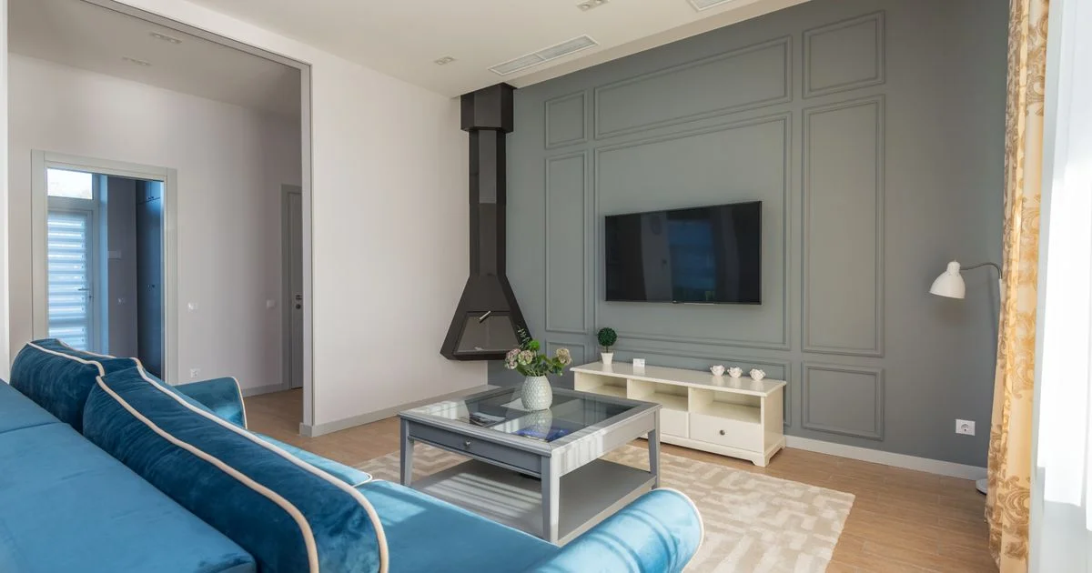 Wall-mounted flat screen in a bright living room, the room light an affordable smart TV has to cope with