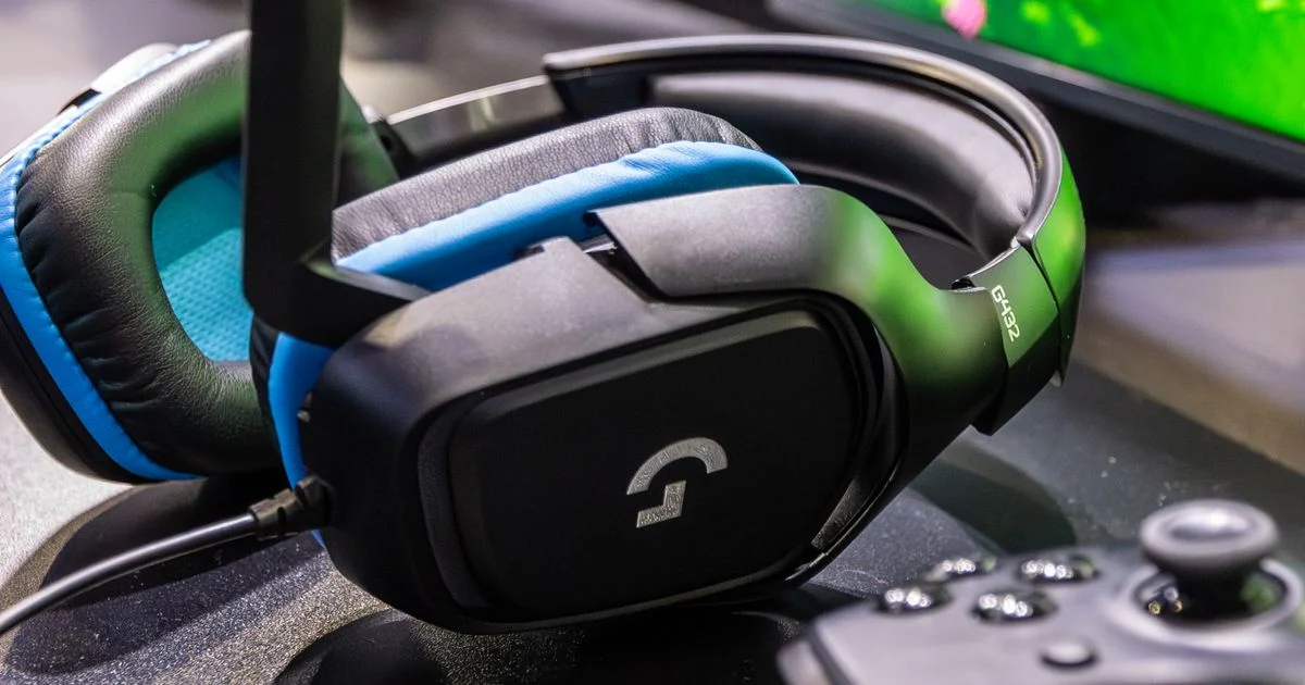 Budget gaming headset with microphone next to a controller and monitor