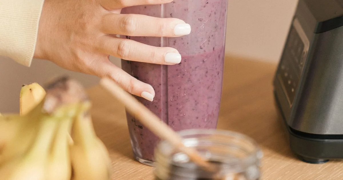 Person holding a portable blender bottle filled with a fresh smoothie, the kind of best portable blender for smoothies buyers look for