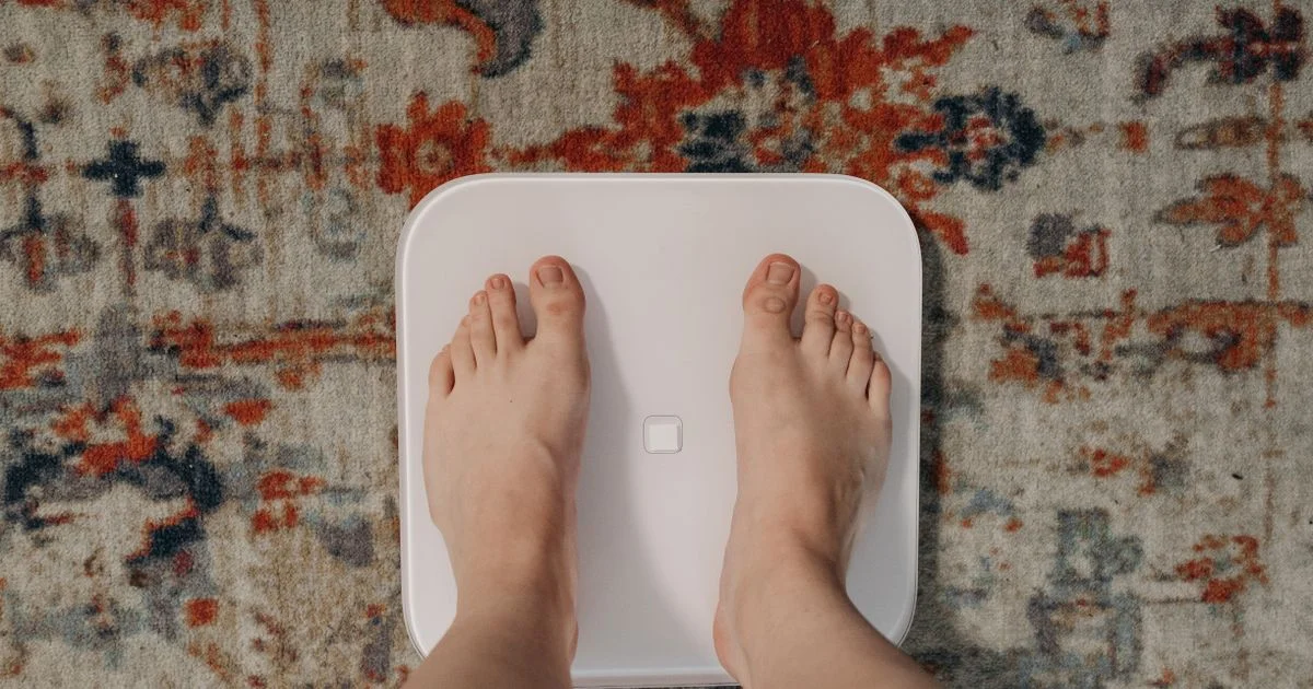 Person standing on a smart body composition scale