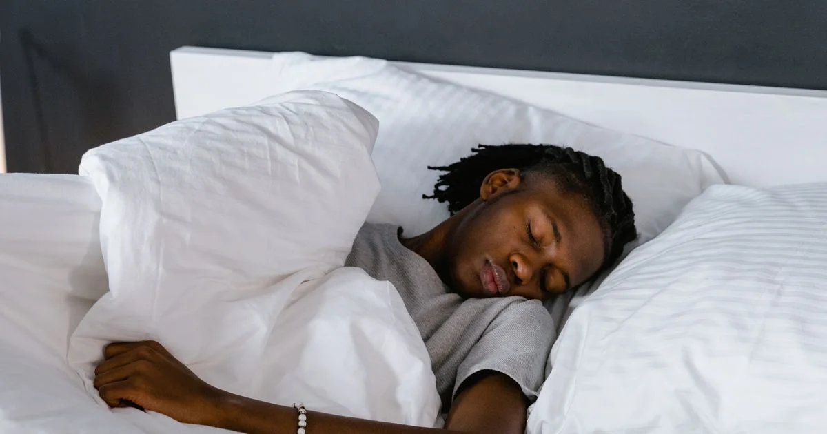 Adult asleep on a plain white pillow, the everyday alternative to a cheap smart pillow