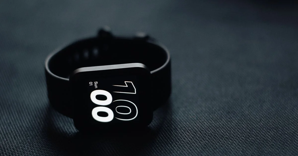 Plain black square-faced smartwatch with a silicone strap, the kind of device a cheap smartwatch under $200 budget buys