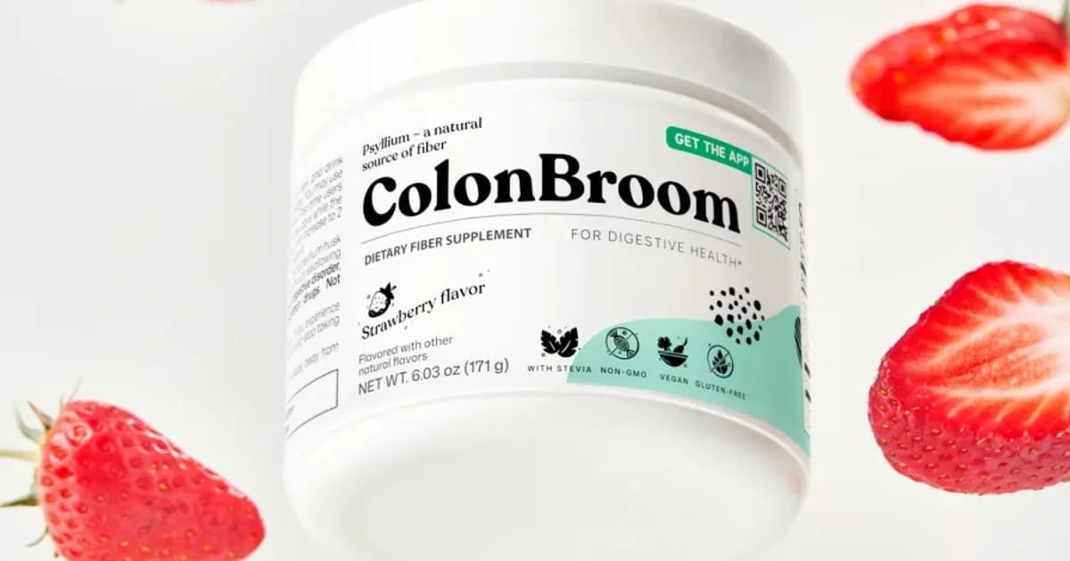 ColonBroom strawberry psyllium jar surrounded by strawberries, reviewed as an affordable fiber supplement for gut health