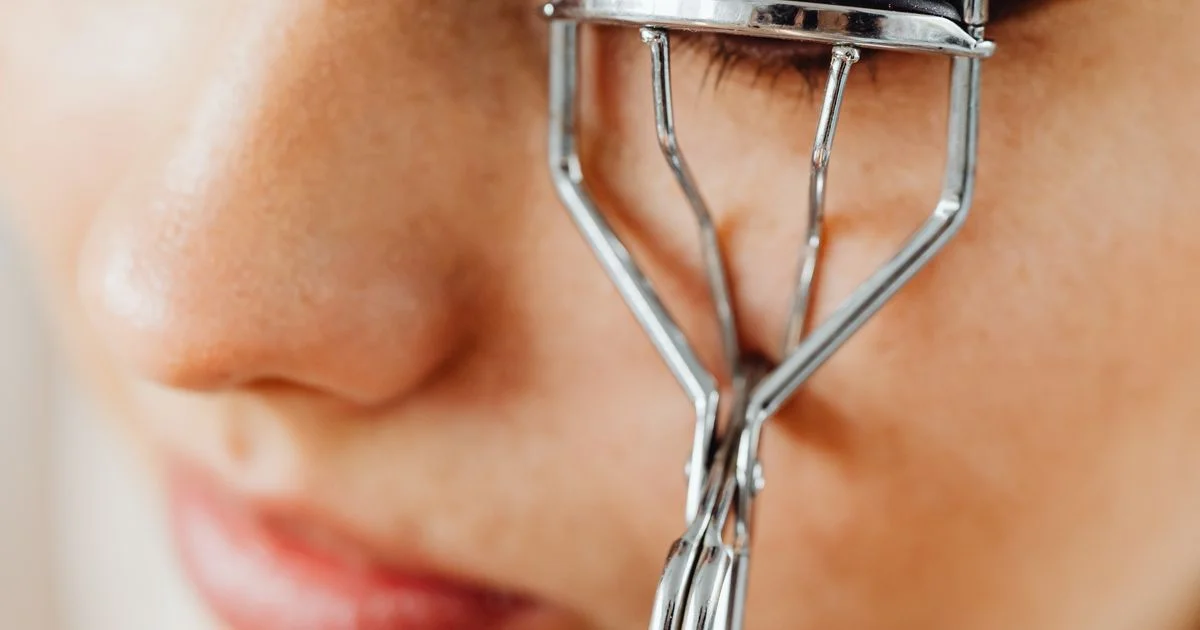 Metal eyelash curler held against lashes, the tool a heated eyelash curler under $20 replaces