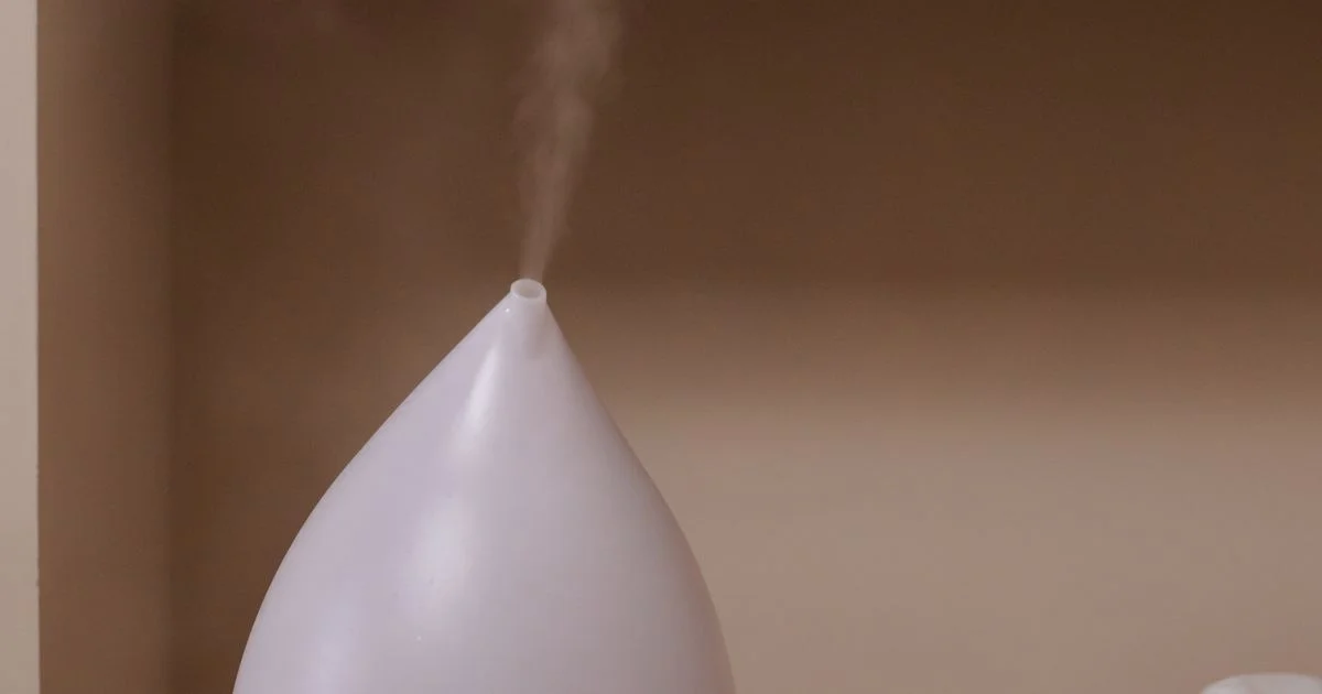 A cool-mist humidifier releasing a plume of vapor indoors, the kind shoppers weigh up when comparing humidifier deals 2026