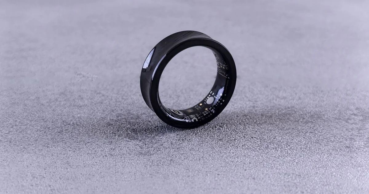Black smart ring with its internal sensor board visible, the screenless device behind any invisible health tracker price question