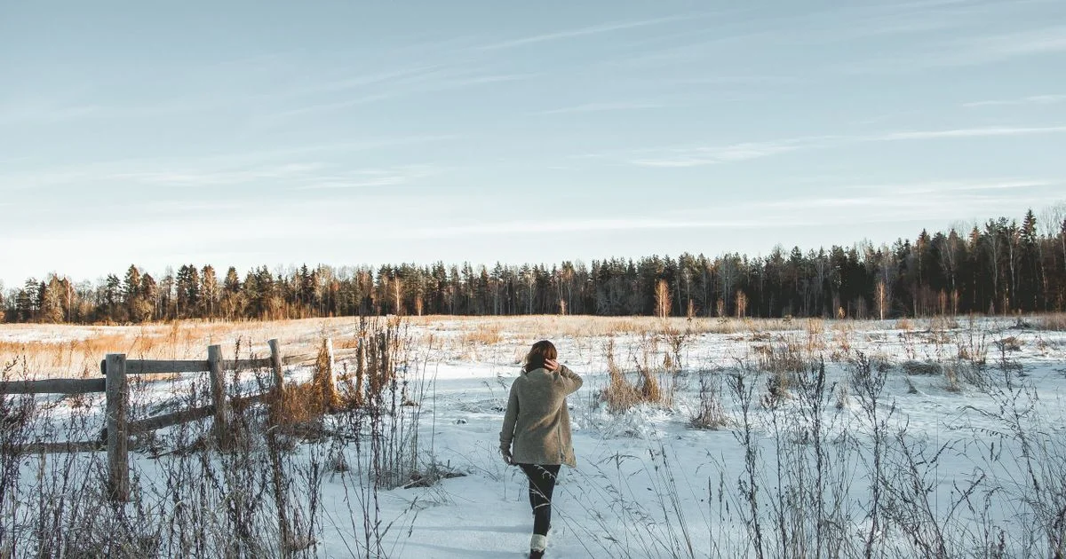 A person walking in bright winter daylight outdoors, the free comparison when asking is light therapy lamp worth it