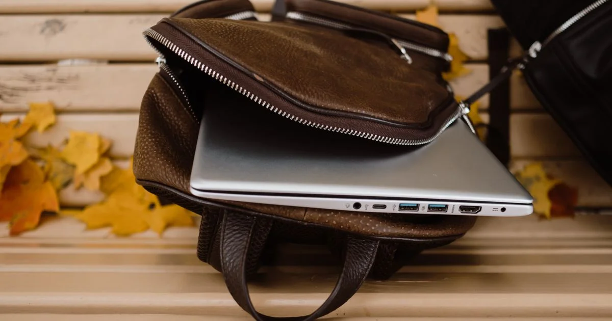 A thin laptop in an open bag with its port row facing the camera, the detail a lightweight laptop price never lists