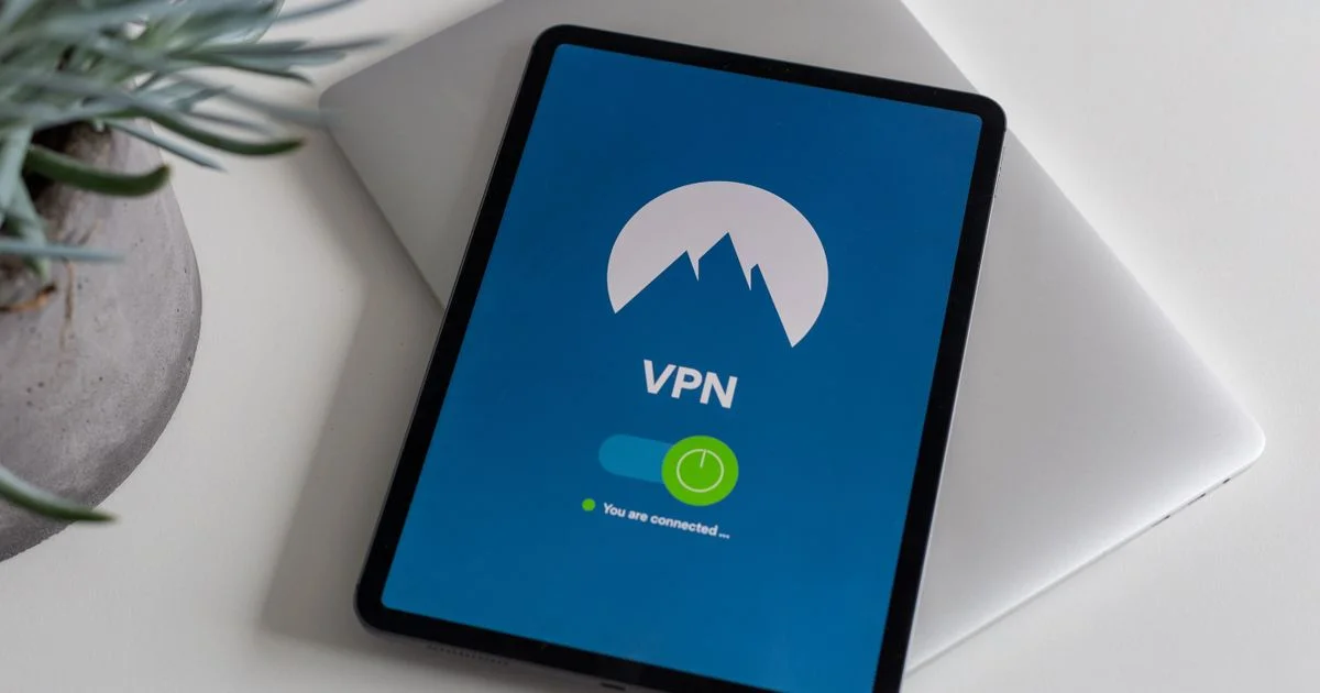 Tablet displaying a connected VPN app on a laptop — NordVPN vs Proton VPN value comparison