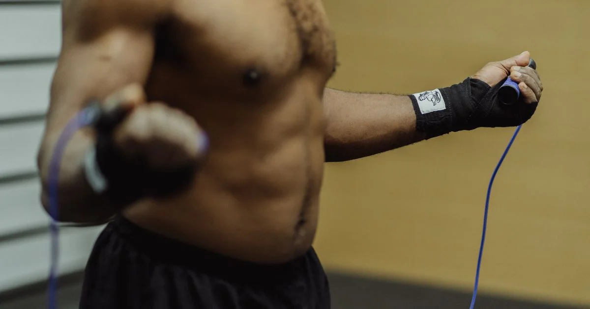 A person mid-workout with a thin PVC jump rope, the entry tier below any smart jump rope price