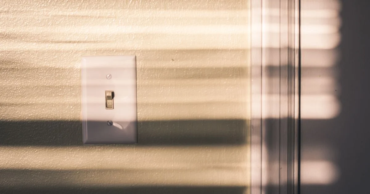 Standard American toggle wall switch in sunlight, the starting point for any smart light switch price comparison