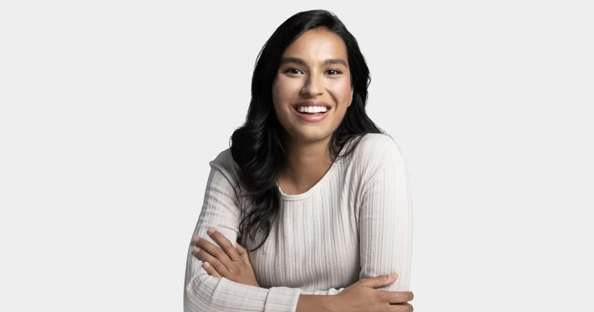 Smiling Udemy learner with arms crossed, illustrating the question is online learning platform worth it