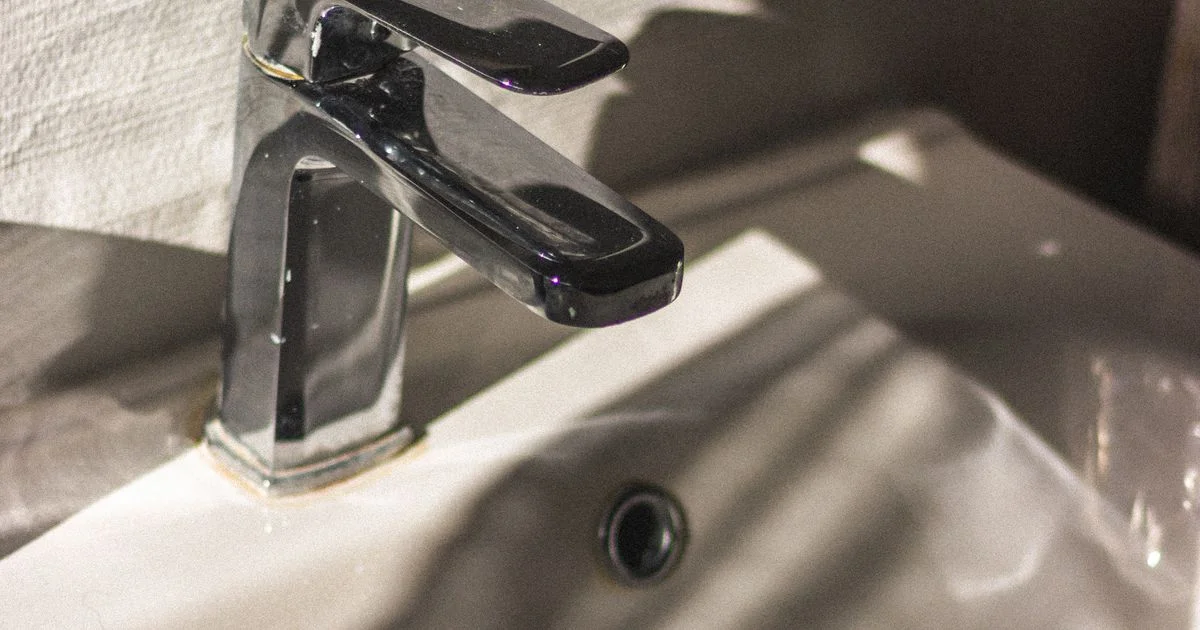 Chrome single handle fixture on a white ceramic basin, the kind of tap a bathroom faucet under $100 replaces