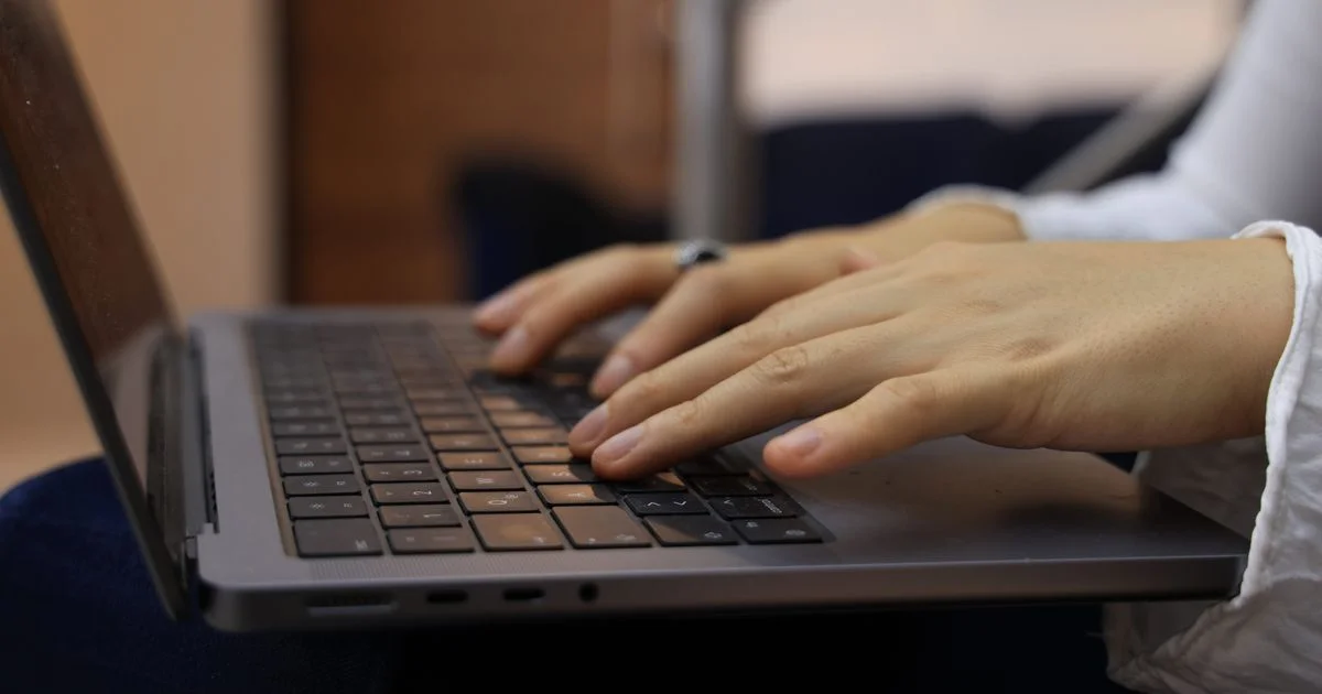 Hands typing on a laptop keyboard, the daily work priced by best budget email client deals 2026